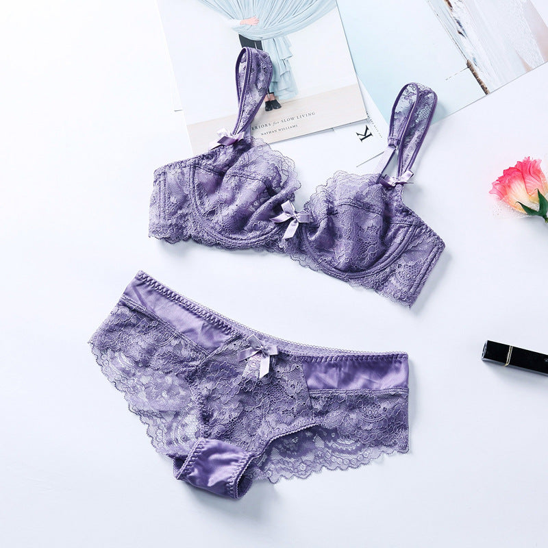 Purple lace lingerie set featuring a balconette bra and matching briefs, adorned with delicate ribbon details, elegantly styled against a light background.