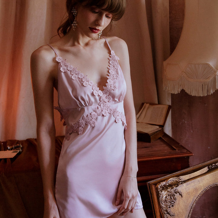 Elegant pink lingerie nightgown with lace detailing, featuring adjustable straps and a flattering V-neckline, perfect for a romantic evening.