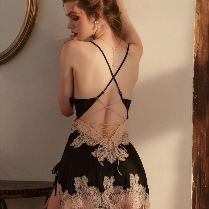 Elegant black lingerie nightgown with lace detailing, featuring a crisscross back design and a feminine silhouette.