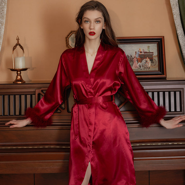Elegant red satin robe with faux fur cuffs, perfect for luxurious nightwear and lounging.