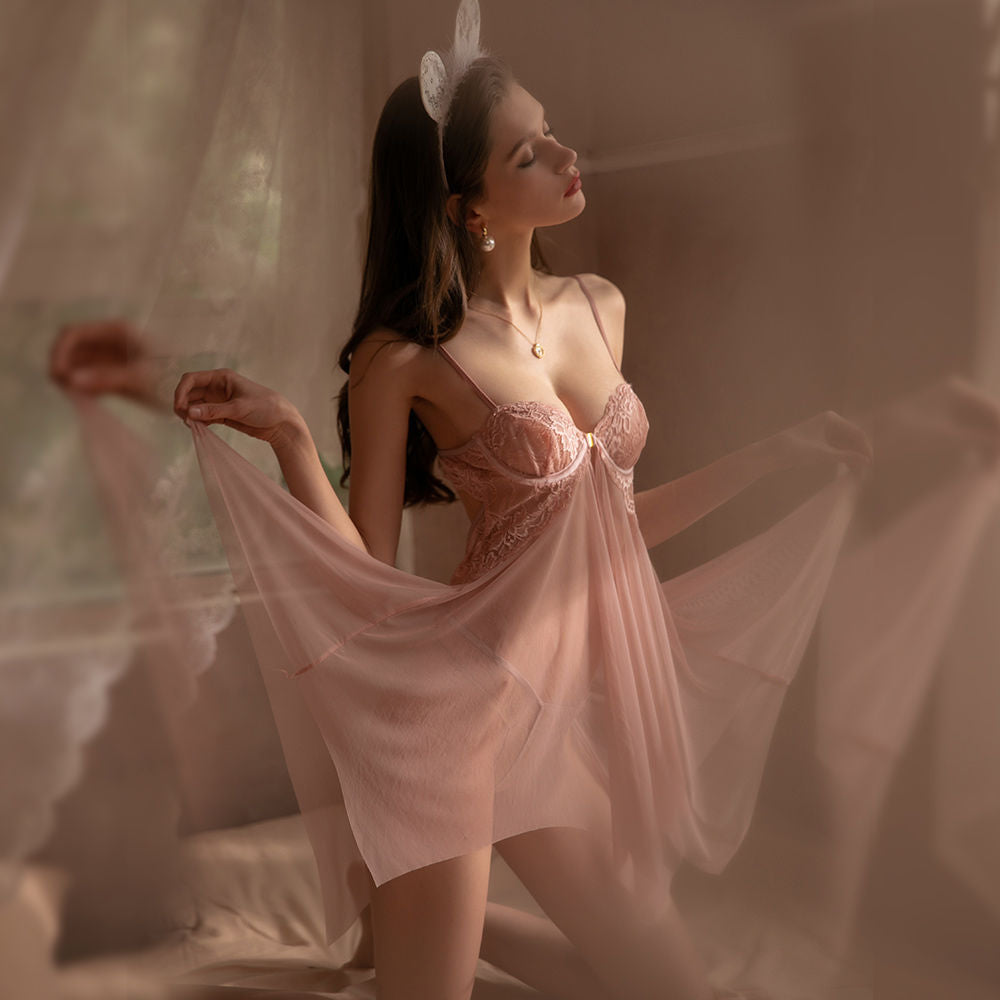 Elegant pink lingerie set featuring delicate lace detailing and a flowing sheer overlay, styled with a model showcasing a graceful pose.