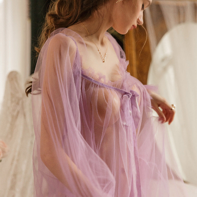Sheer lavender nightgown with ruffled edges and a tie detail, elegantly draped on a model.