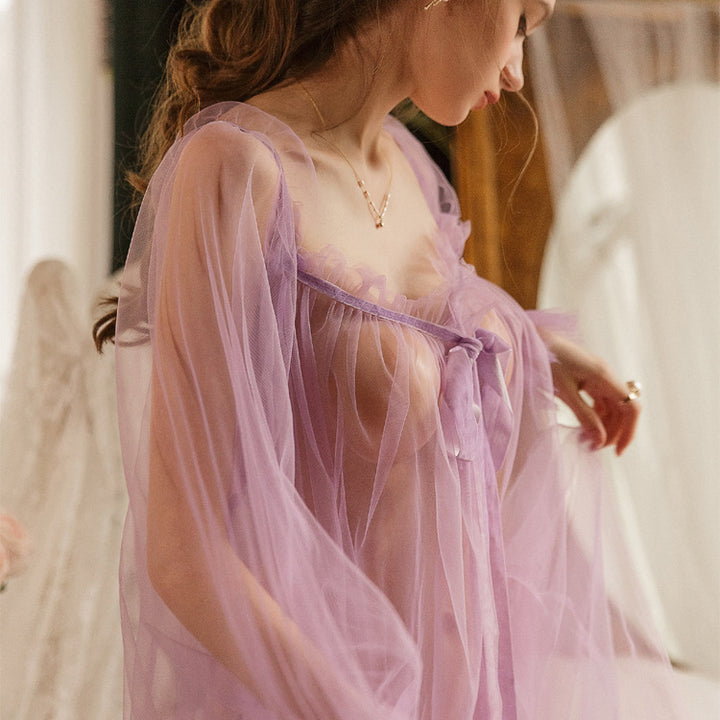 Sheer lavender nightgown with ruffled edges and a tie detail, elegantly draped on a model.