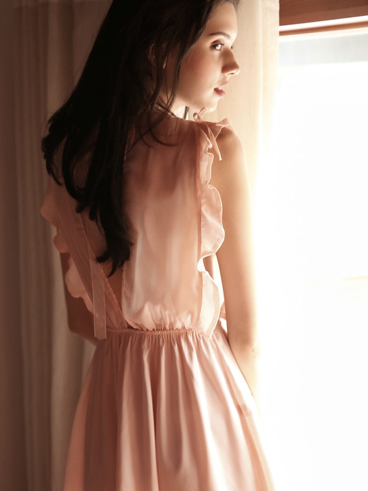 Elegant blush nightgown with ruffled shoulders and a cinched waist, perfect for a romantic evening.