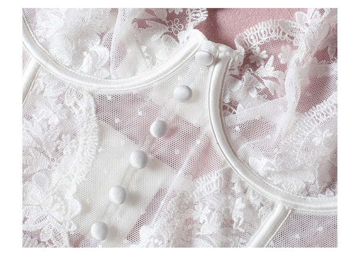 Delicate white lace nightgown featuring intricate floral patterns and button detailing.
