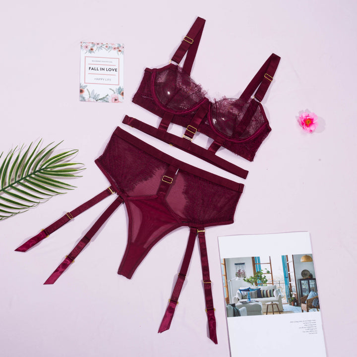 Burgundy lace lingerie set featuring a chic bralette with adjustable straps and a matching sheer thong with garter straps, styled against a light background with