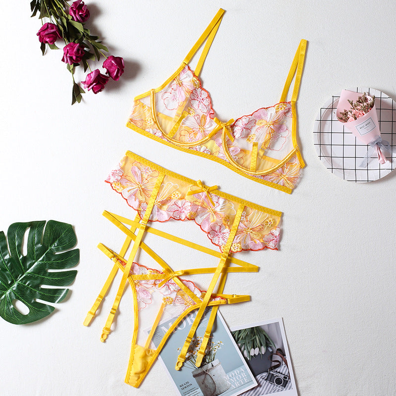 Yellow floral lace lingerie set featuring a bralette and matching thong, accented with delicate straps and a romantic design.