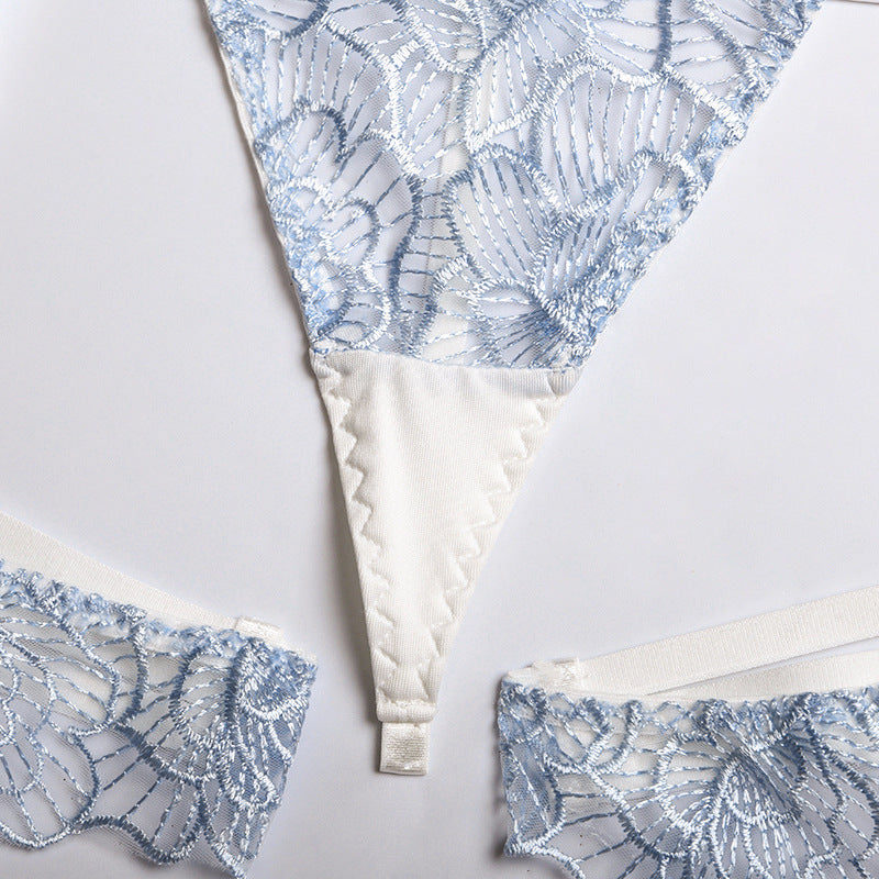 Delicate blue lace thong with floral embroidery and soft satin details, perfect for adding a touch of elegance to your lingerie collection.