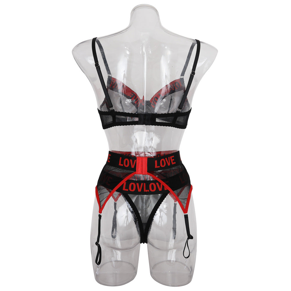 Sheer black lingerie set featuring a bra with thin straps and a matching high-waisted garter belt, accented with bold red "LOVE" text.