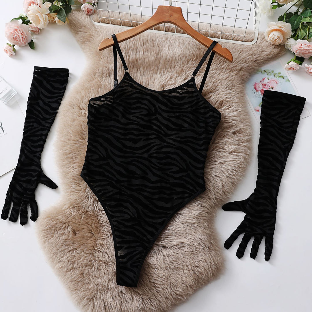 Black tiger print lingerie bodysuit featuring adjustable straps, paired with matching long gloves. The ensemble is elegantly displayed on a soft beige fur background, perfect