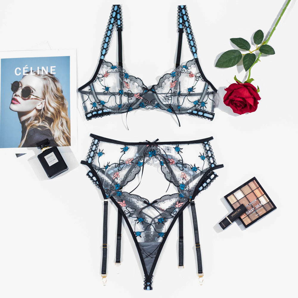 Lingerie set featuring a black sheer bra adorned with intricate floral embroidery in blue and pink, paired with matching high-waisted sheer panties with garter