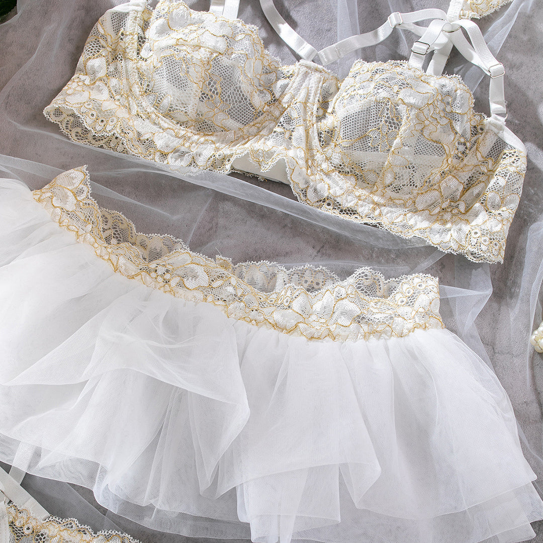 Lacy white and gold lingerie set featuring a beautifully crafted bra with intricate lace details and a matching flared tulle skirt. Ideal for special occasions or