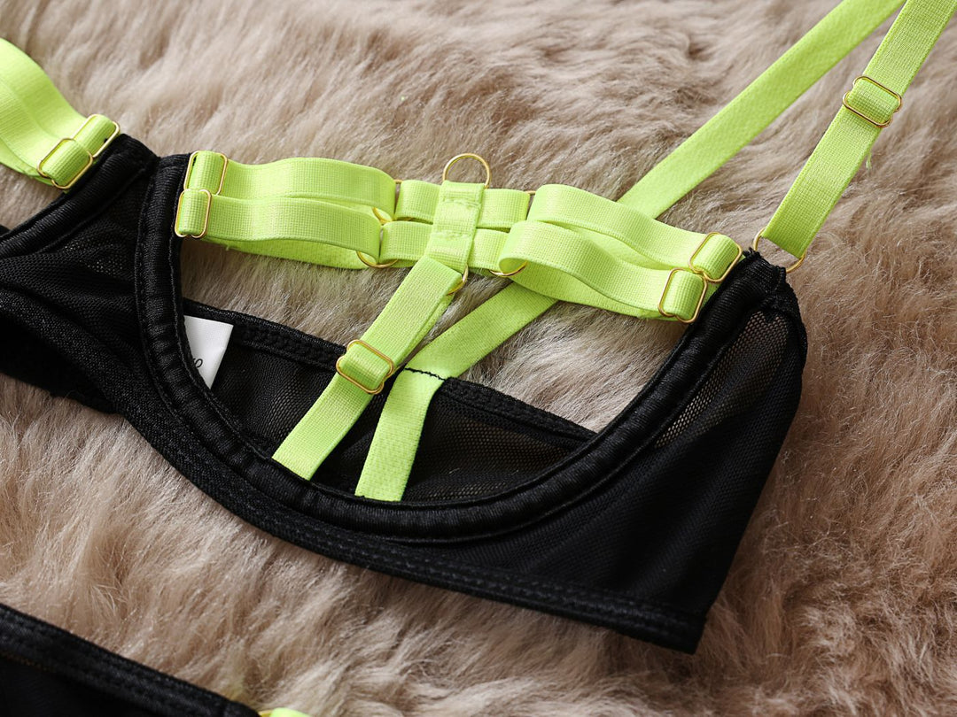 Black lingerie bralette featuring neon green straps and metallic accents, designed for a modern and edgy look.