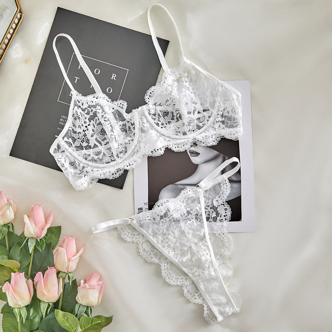 Elegant white lace lingerie set featuring a delicate bralette with scalloped edges and adjustable straps, paired with matching lace thong. The set is displayed on a