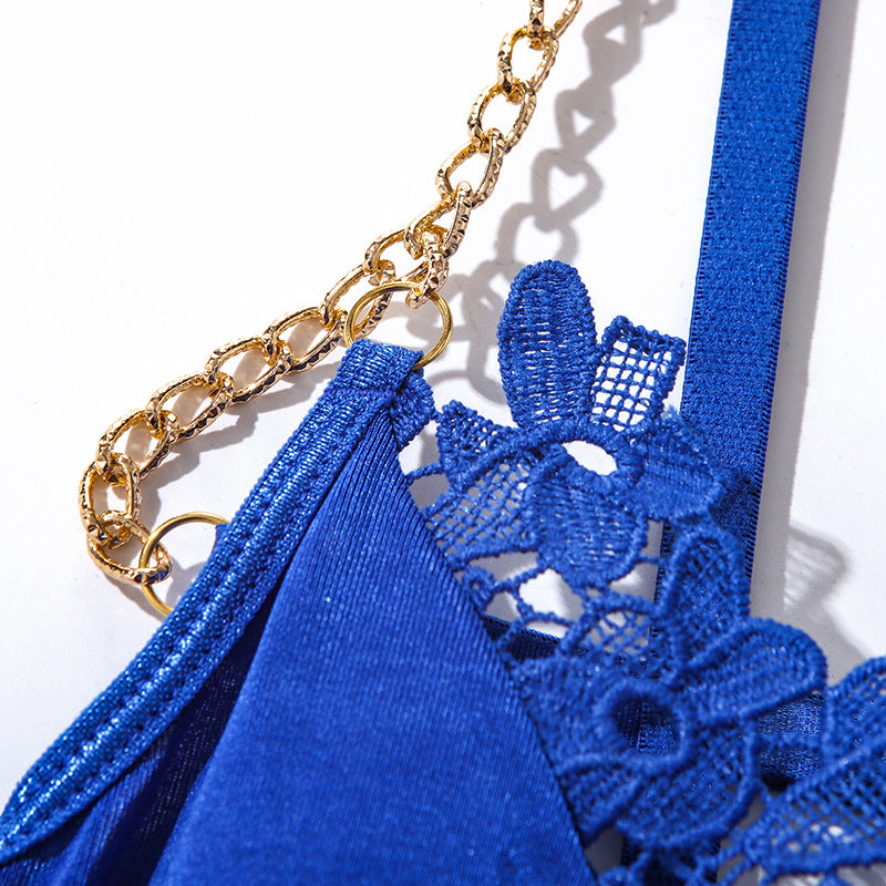 Royal blue lingerie featuring delicate lace and a gold chain detail, designed for a luxurious and elegant look. This intricately crafted piece combines soft fabric with intricate