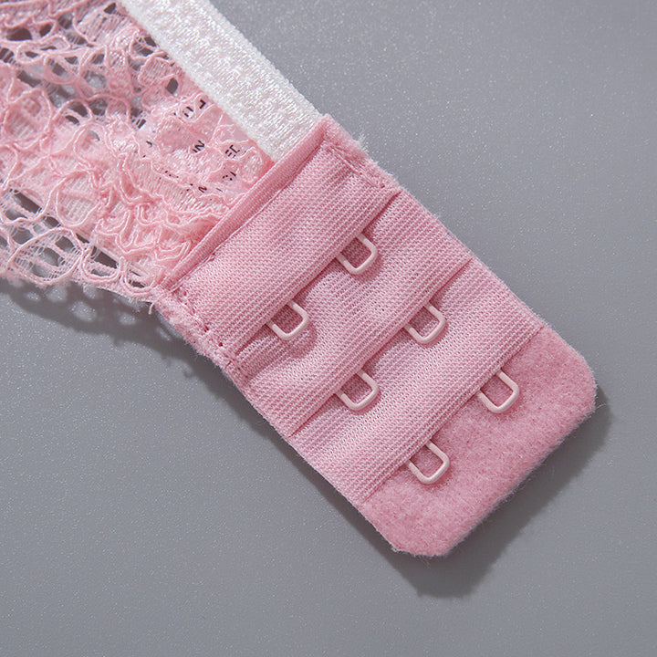 Close-up of a pink lingerie hook-and-eye closure featuring intricate lace detailing.