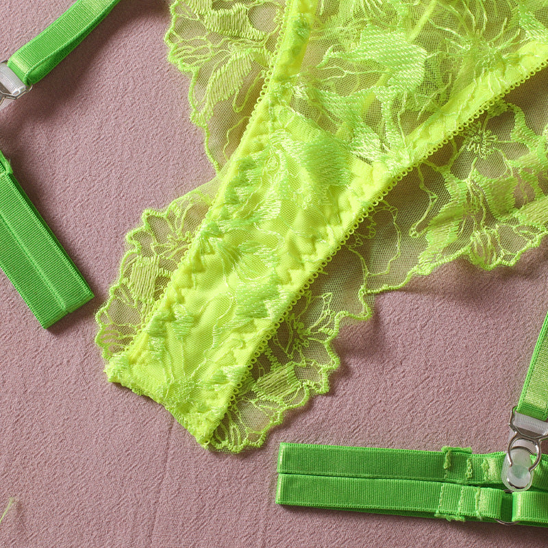 Neon green lace lingerie set with floral detailing and adjustable straps on a soft background.