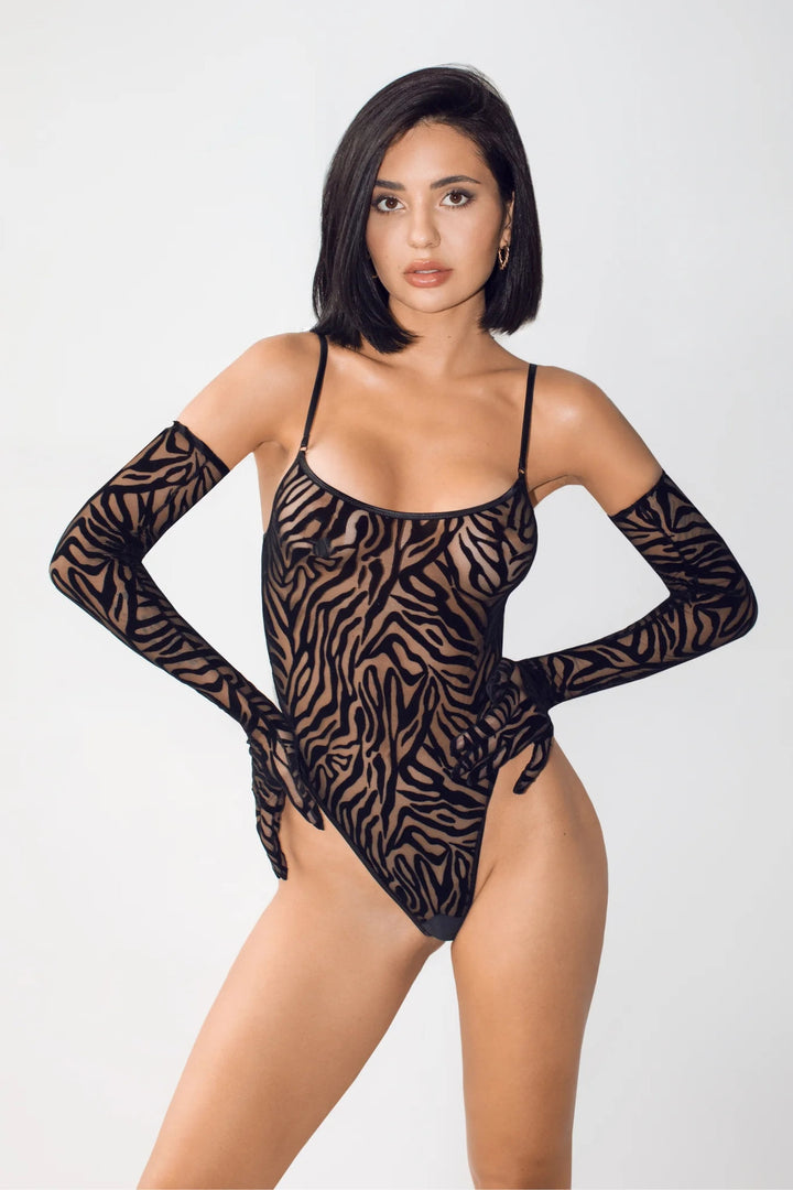 Seductive black mesh bodysuit with a zebra print design, featuring long, fitted sleeves and a daring cut. Perfect for adding a touch of bold