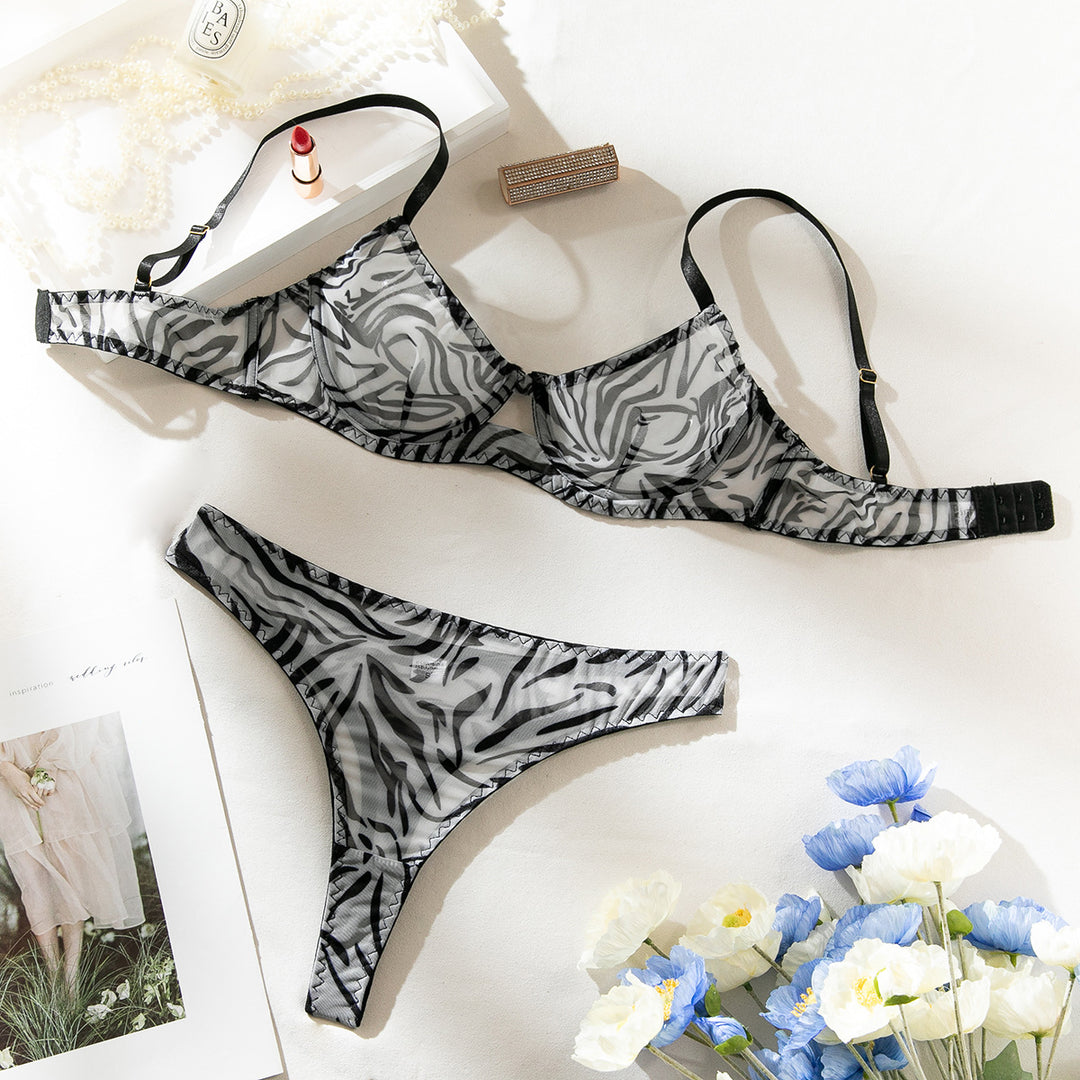 Zebra print lingerie set featuring a structured bra and matching thong, elegantly displayed with floral accents.