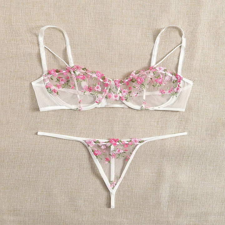 Floral lace lingerie set featuring a sheer bralette with intricate pink flower embroidery and matching thong. Perfect for romantic occasions, this delicate two-piece set combines