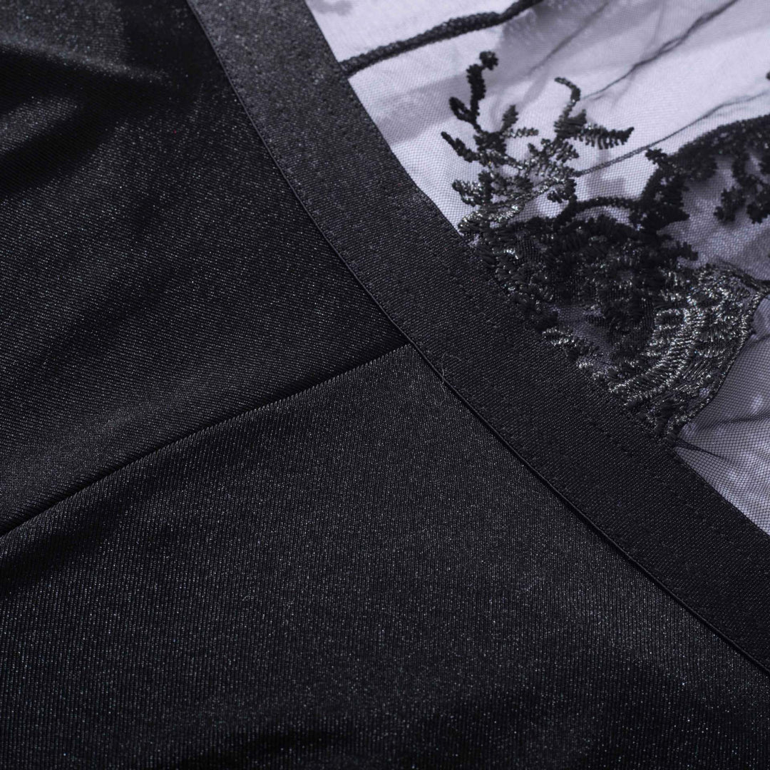 Black lingerie featuring intricate lace detailing on sheer fabric, highlighting elegance and sophistication.