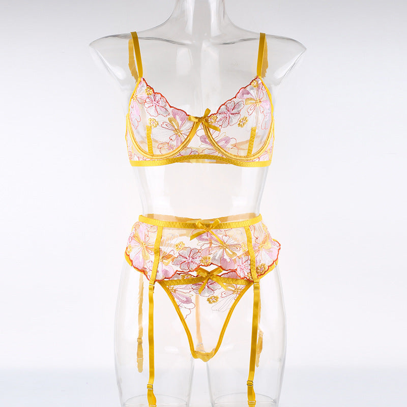 Lace lingerie set featuring a floral design in pink and yellow with adjustable straps and matching garter belt.