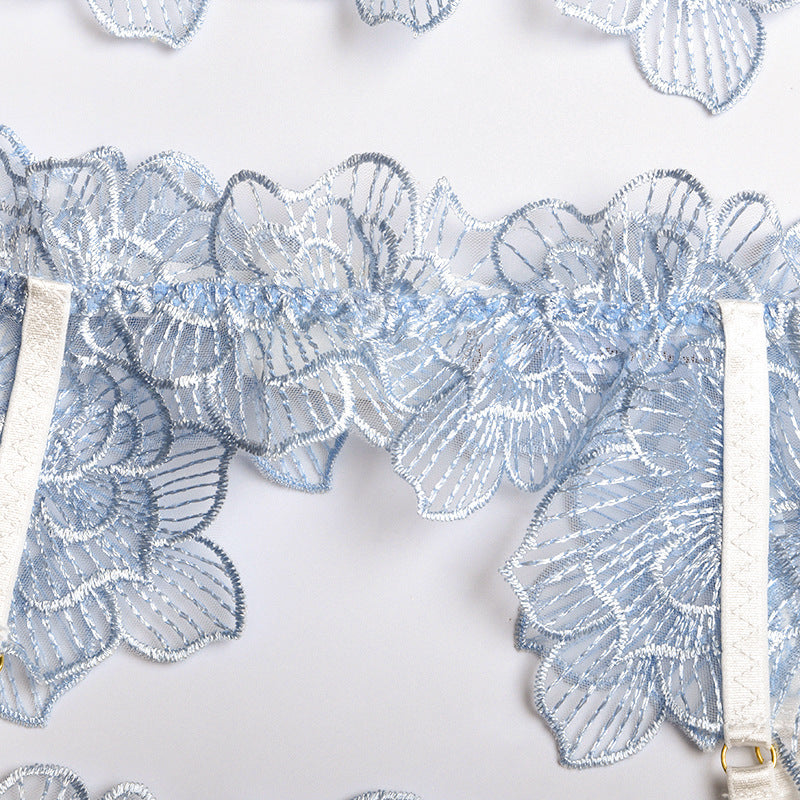 Delicate light blue floral lace embroidery with satin straps, perfect for elegant lingerie pieces.