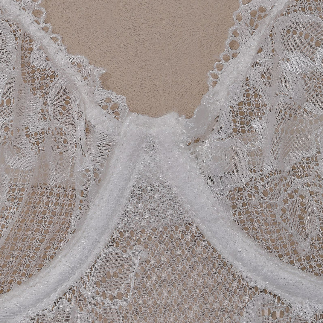 Delicate white lace lingerie featuring intricate floral patterns and sheer fabric, perfect for adding a touch of elegance to your intimate collection. Ideal for special occasions or