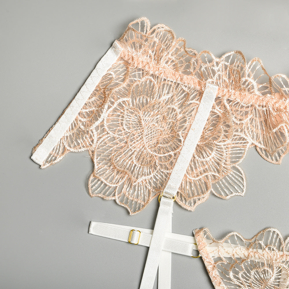 Delicate floral lace lingerie set in soft peach with white adjustable straps, perfect for a romantic night.