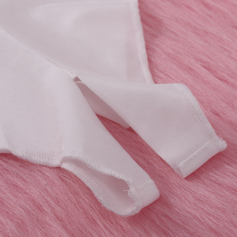 Close-up of soft white lingerie straps on a pink fur background.
