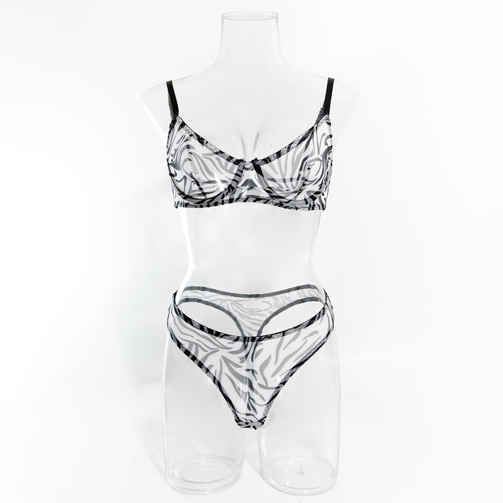 Sheer black and white zebra print lingerie set featuring a bralette and matching thong on a mannequin.