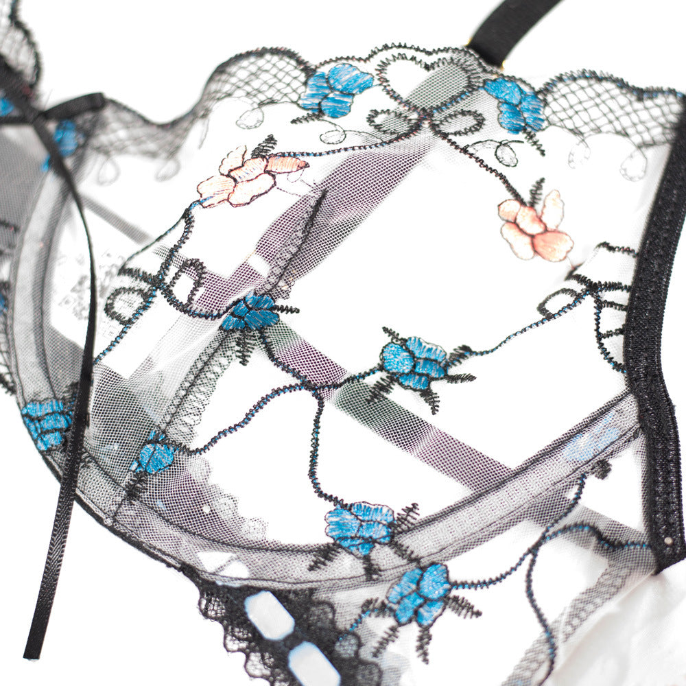 Lace bralette featuring intricate floral embroidery in blue and pink hues on a sheer black mesh fabric, perfect for adding a touch of elegance to any lingerie