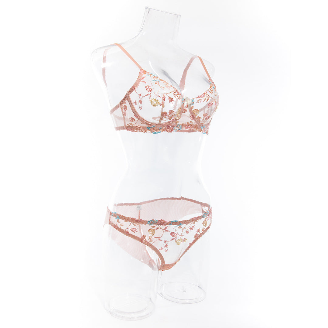 Embroidered sheer lingerie set featuring floral designs in soft peach tones, including a bralette and matching panties.