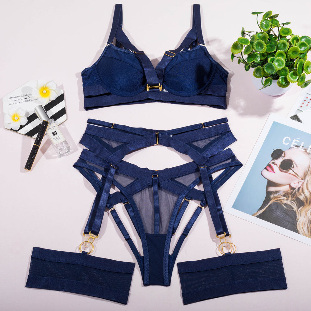 Navy blue lingerie set featuring a structured bra and garter belt with decorative strapping details, accompanied by matching thigh bands, styled with a modern aesthetic