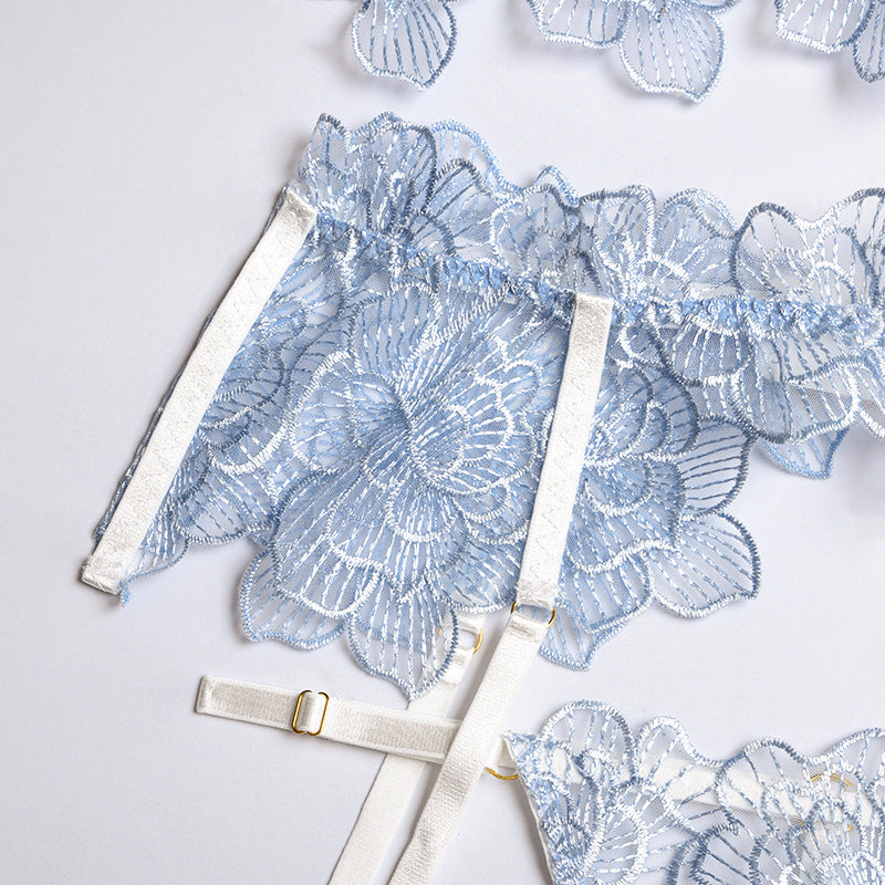 Light blue lace lingerie with floral patterns and adjustable straps.