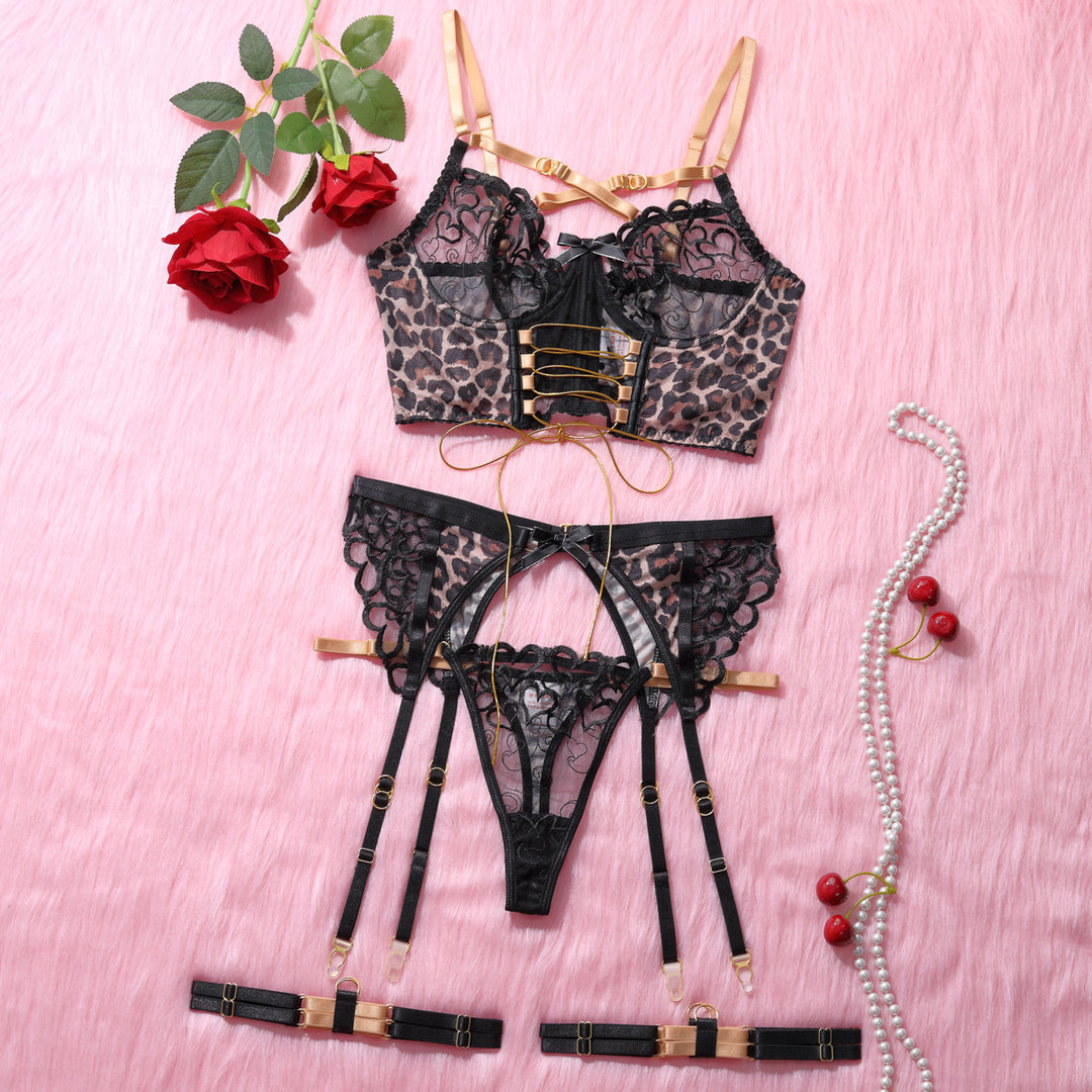 Leopard print lingerie set featuring a sheer lace bra with gold accents, matching lace panties, garter belt with adjustable straps, and decorative details. Styled