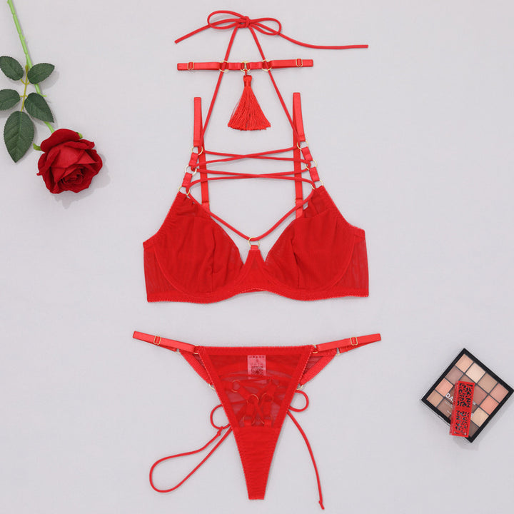 Red strappy lingerie set featuring a bralette with intricate lace detailing and matching thong underwear, designed for a seductive look. Styled with a decorative tassel