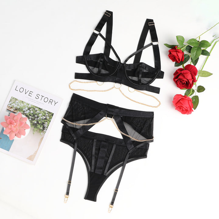 Black lingerie set featuring a strappy bra and high-waisted panties with delicate chain details. The bra has adjustable straps and a structured design, while the