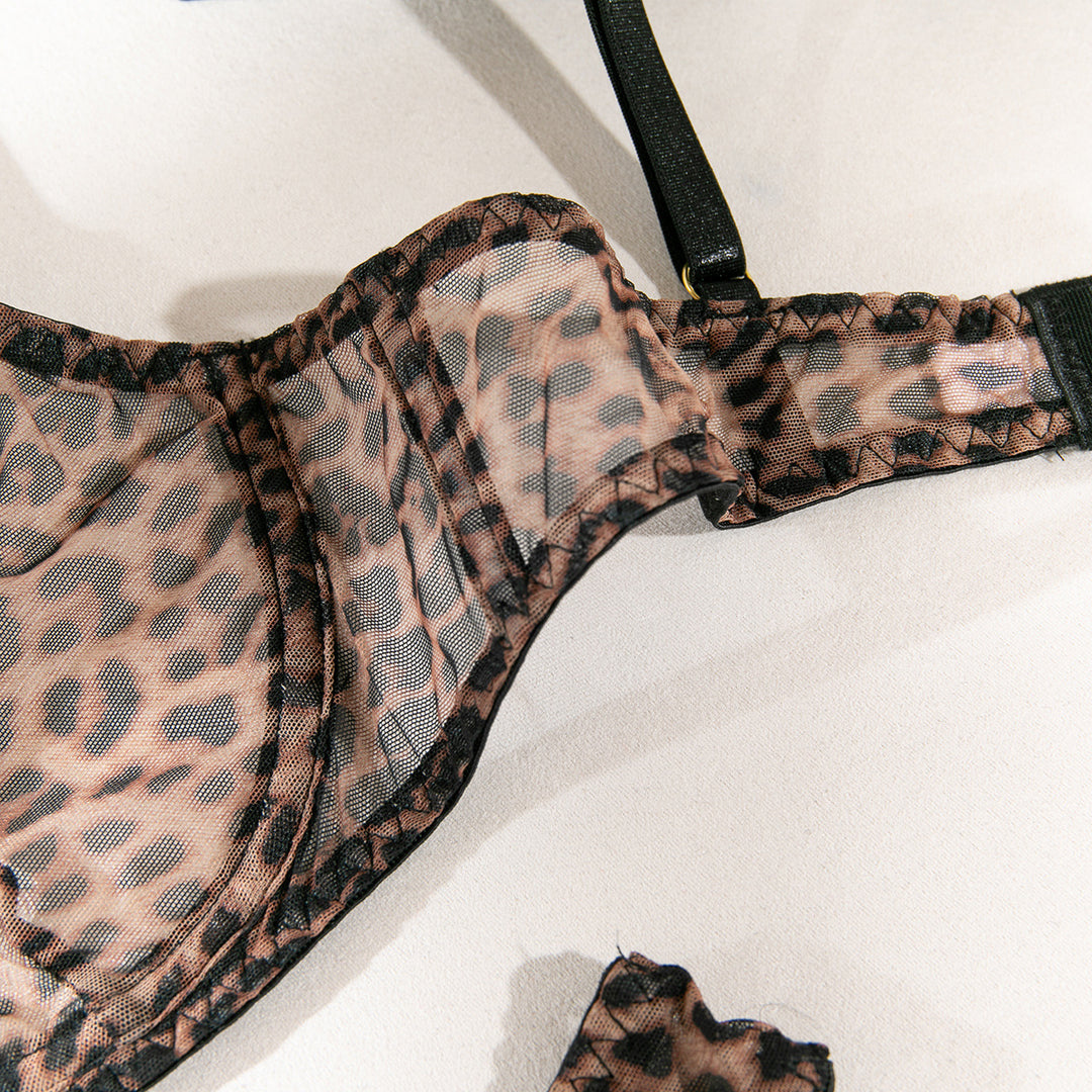 Sheer leopard print bra with black lace detailing and adjustable straps.