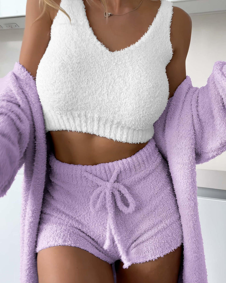 Cozy loungewear set featuring a white fluffy crop top and lilac soft shorts, perfect for relaxation and sleep.