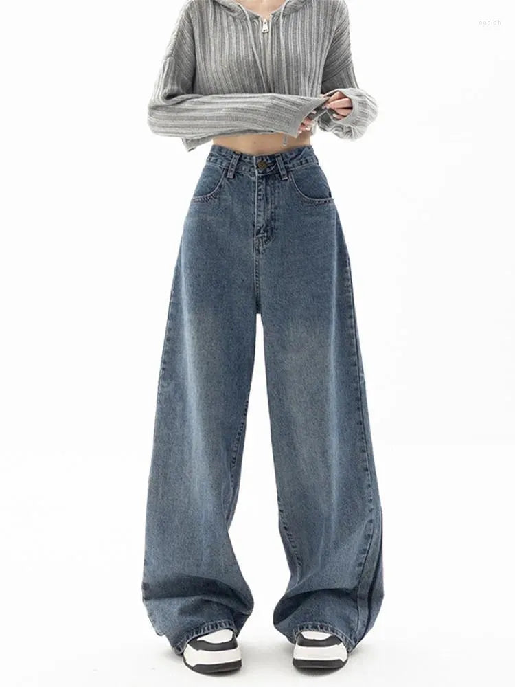 Denim wide-leg jeans styled with a cropped grey hoodie and sneakers, showcasing a relaxed fit perfect for casual wear.