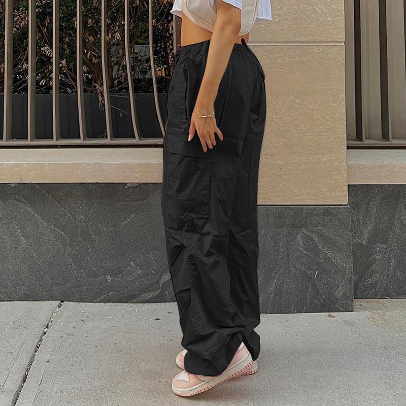 Model wearing stylish black cargo pants paired with a crop top, showcasing a casual street style look.