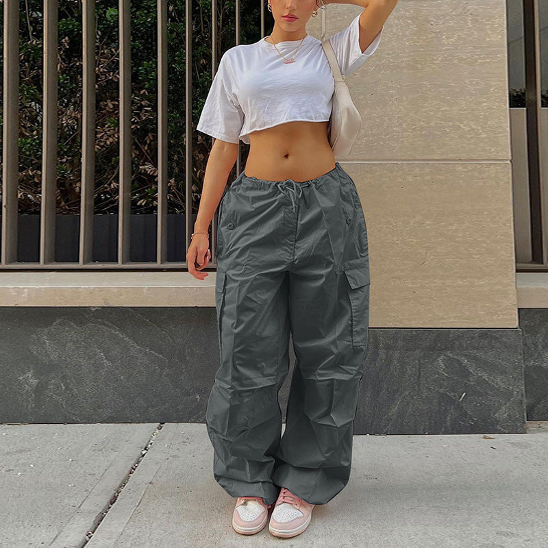 Comfortable cropped white t-shirt paired with loose grey cargo pants, styled for a trendy casual look.