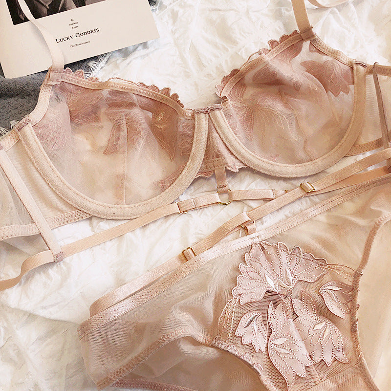 Sheer lace lingerie set featuring a floral design with adjustable straps in a soft nude color.