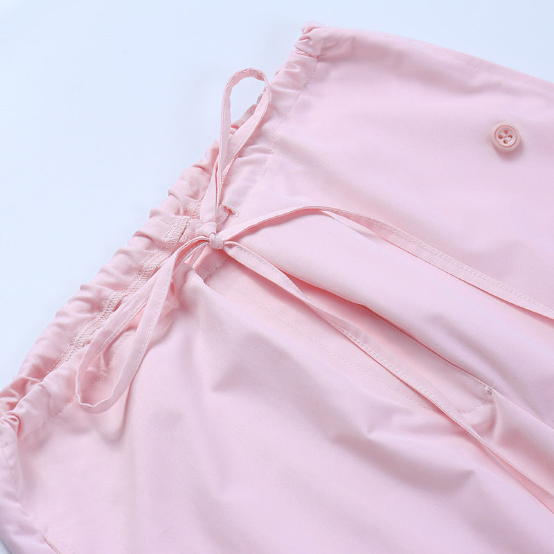 Light pink women's nightwear featuring a soft elastic waistband, adjustable tie, and button detail. Ideal for a comfortable and stylish bedtime look.