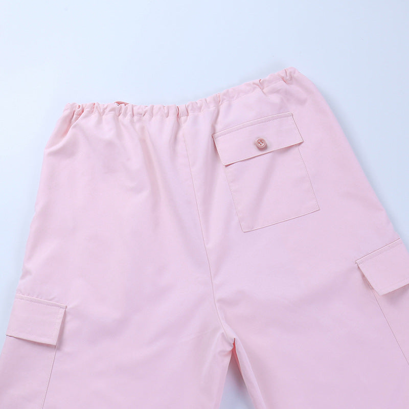 Light pink cargo pants with elastic waistband and side pockets.