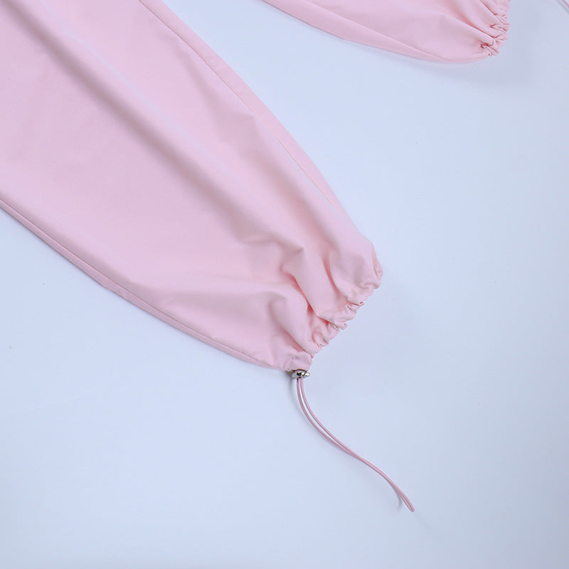 Pink long-sleeve sleepwear with elastic cuffs and drawstring detail, perfect for comfortable lounging and sleeping.