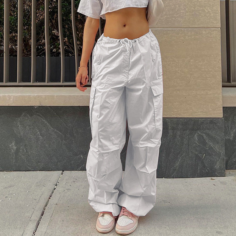 White cargo pants paired with a cropped top, showcasing a casual and stylish streetwear look.