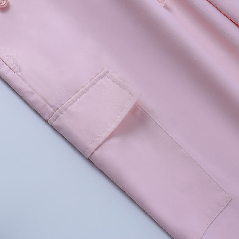 Light pink satin nightwear featuring a button-up design and rolled sleeve detail.