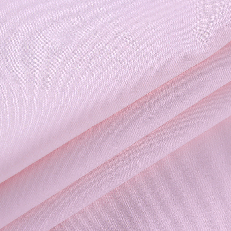 Soft pink fabric, showcasing smooth texture, ideal for lingerie and nightwear.